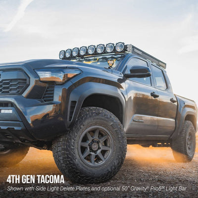 4th generation Toyota Tacoma truck with off-road equipment on a dirt road