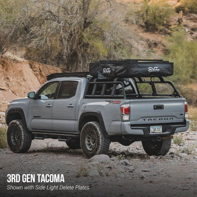 Gray Toyota Tacoma truck with roof rack in a desert setting