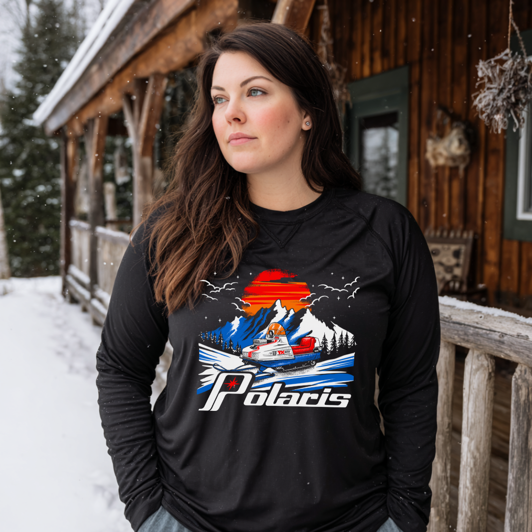 Woman wearing a black long-sleeve shirt with a Polaris graphic in a snowy outdoor setting.