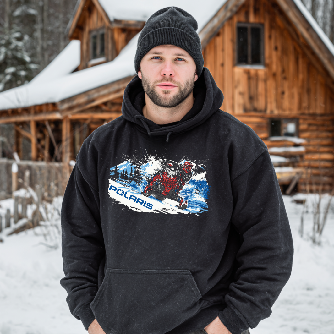 Man wearing a black hoodie with Polaris logo in front of a wooden cabin in the snow