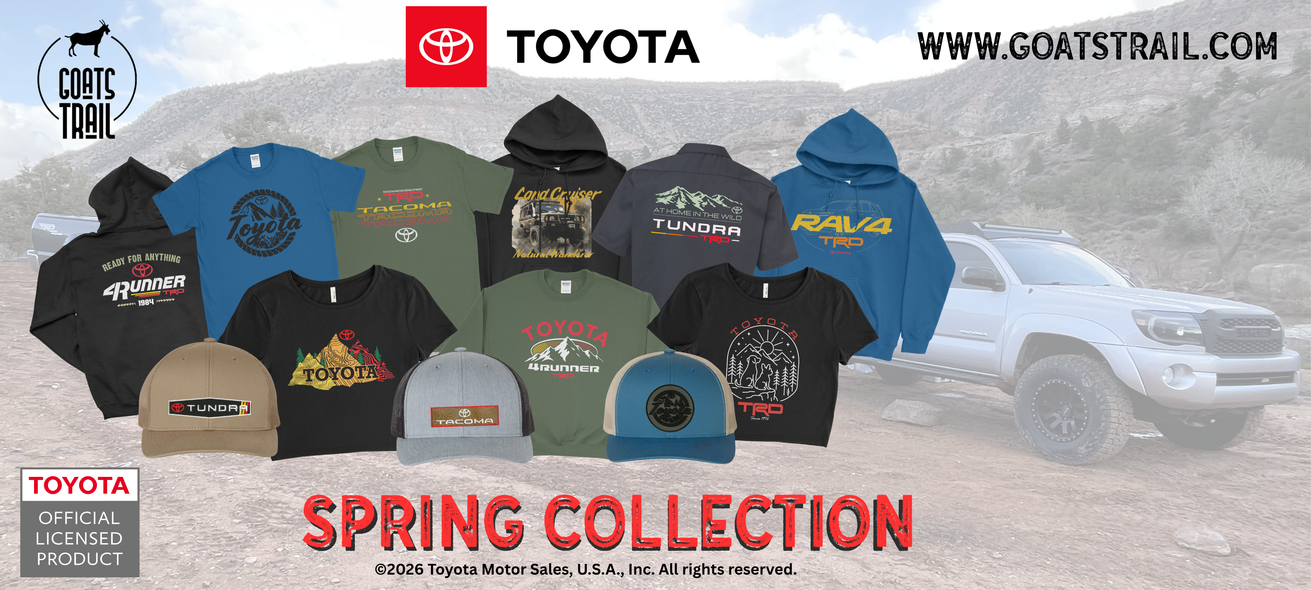 Collection of Toyota-branded hoodies and caps with a blurred truck in the background.