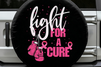 A black circular spare tire cover mounted on a vehicle, featuring the text &