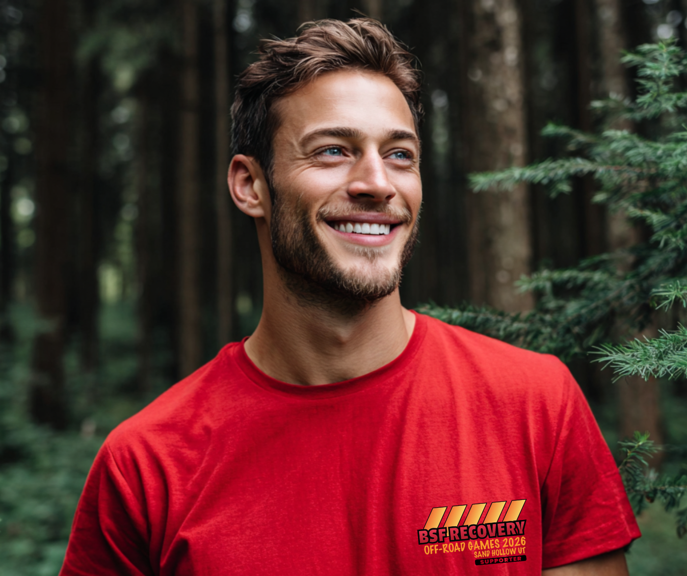 Man wearing a red t-shirt with a logo in a forest