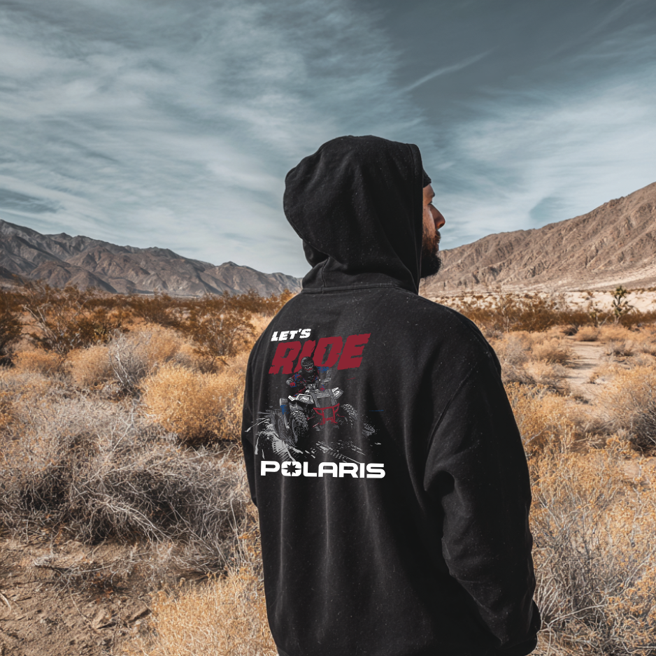 Person wearing a black hoodie with Polaris branding in a desert landscape