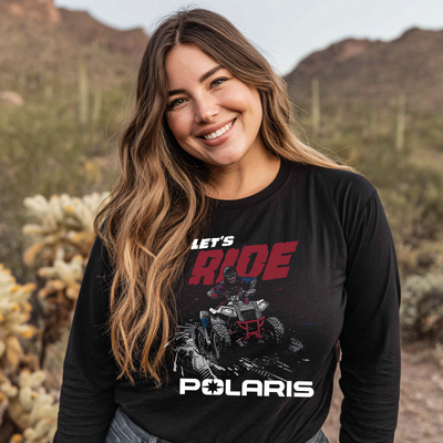 Woman wearing a black Polaris shirt with an ATV graphic in a desert setting