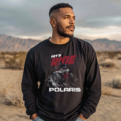 Man wearing a black Polaris sweatshirt with graphics and text in a desert setting