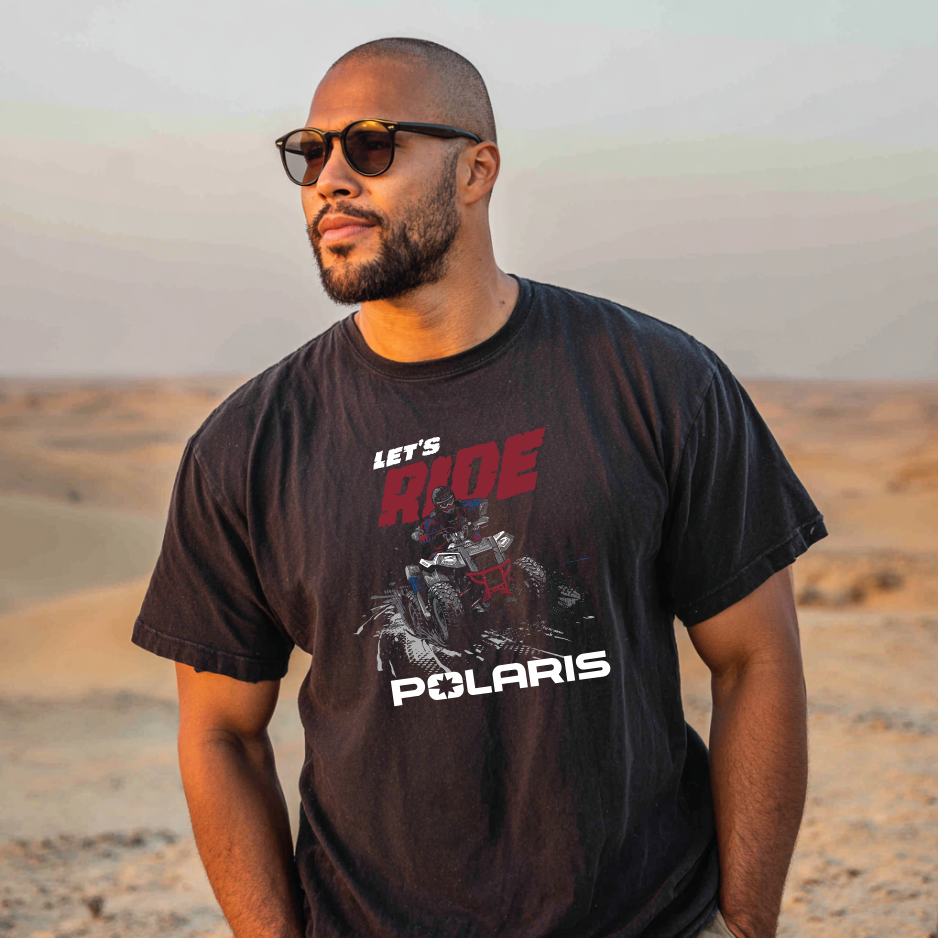 Man wearing a black t-shirt with Polaris graphics and text in a desert setting