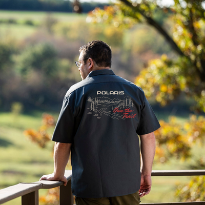 Man wearing a Polaris shirt looking at a scenic view