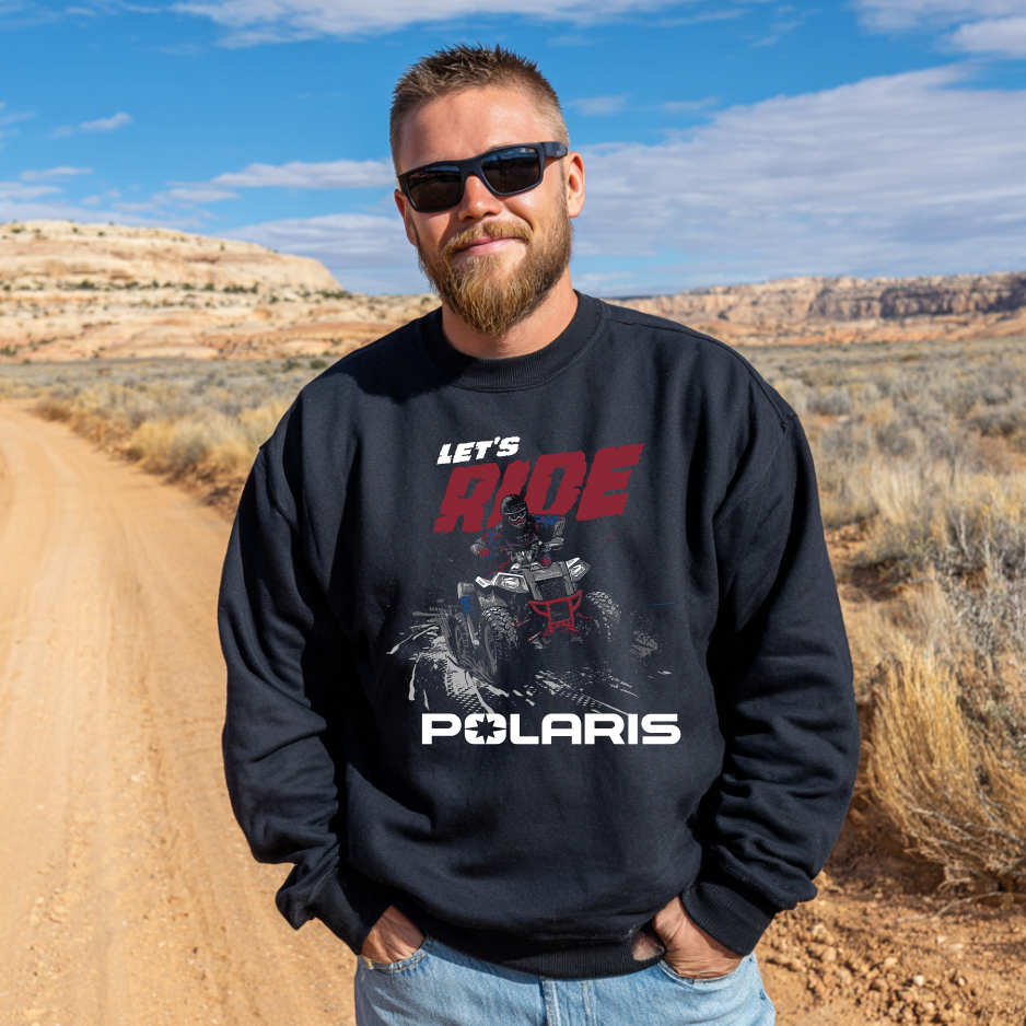 Man wearing a black sweatshirt with Polaris graphics and text in a desert setting