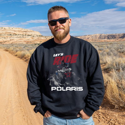 Man wearing a black sweatshirt with Polaris graphics and text in a desert setting