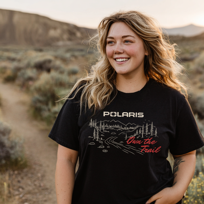 Woman wearing a black Polaris t-shirt in a desert setting