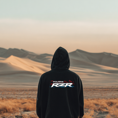 Person wearing a black hoodie with Polaris RZR logo in a desert landscape