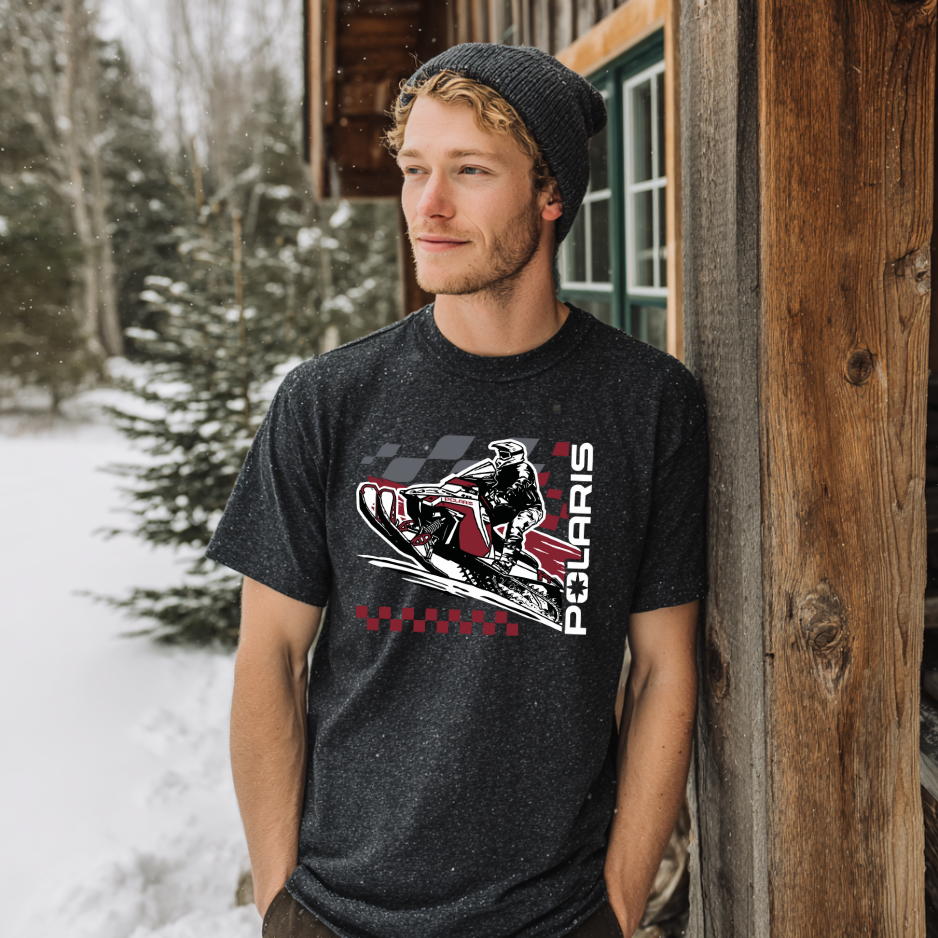 Man wearing a black t-shirt with a Polaris graphic in a snowy outdoor setting