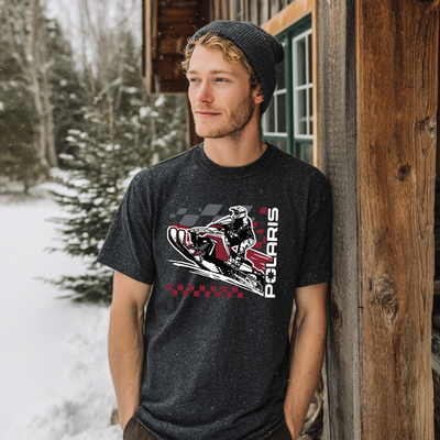 Man wearing a black t-shirt with a Polaris graphic in a snowy outdoor setting