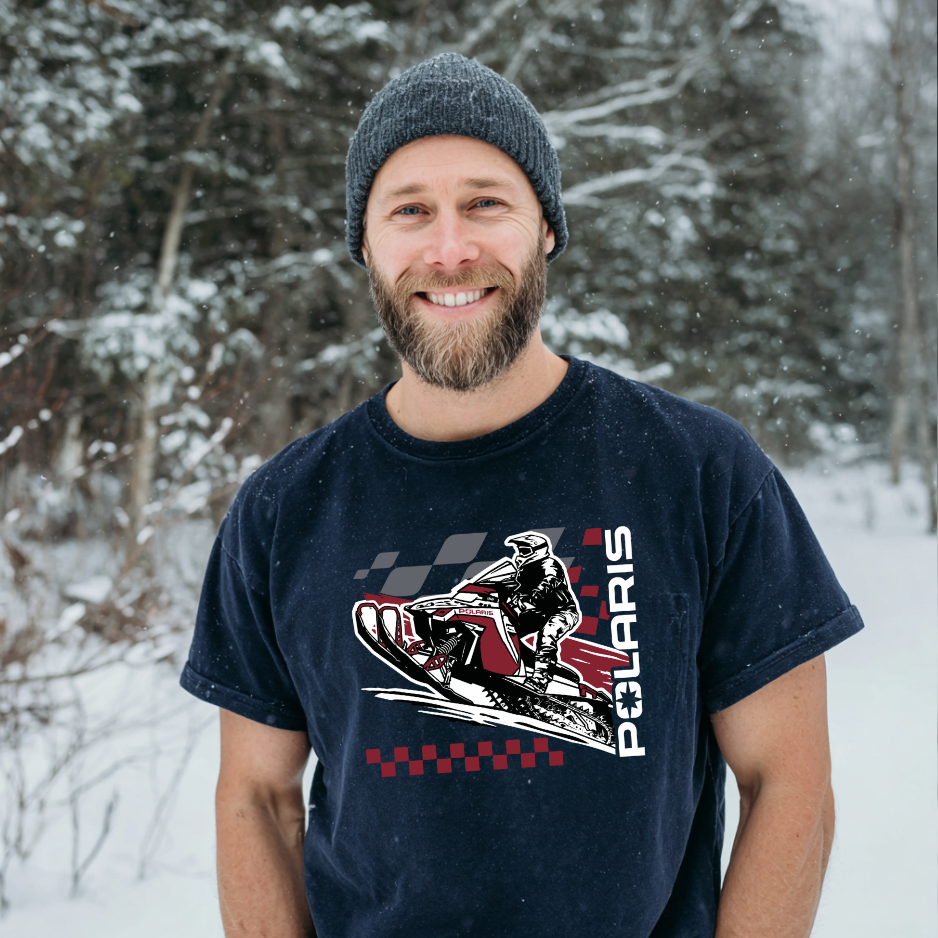 Man wearing a navy blue t-shirt with Polaris graphic in a snowy forest