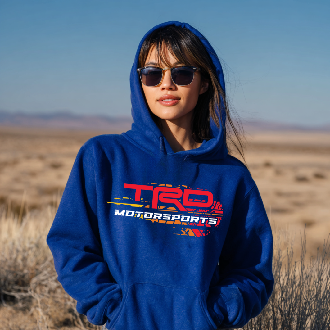Person wearing a blue hoodie with TRD Motorsports logo in a desert setting